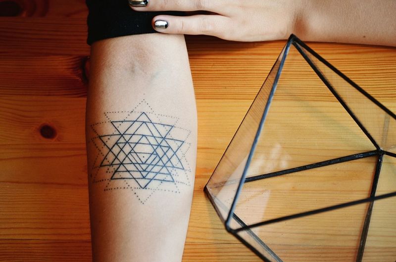 Close-up of geometric tattoo on human arm