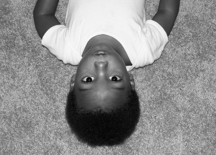 High angle portrait of boy lying on floor