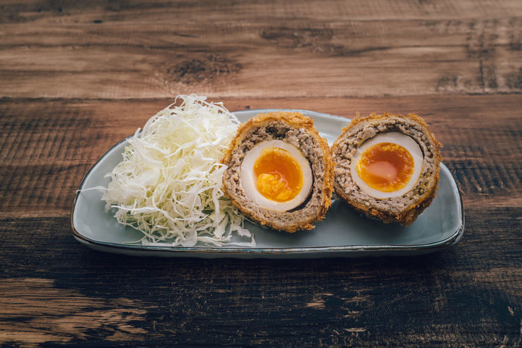 Japanese minced meat cutlet with half boiled egg inside.