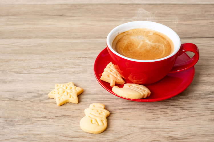 High angle view of coffee and cookies on table