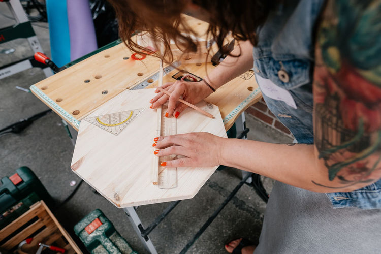 workshop project, creating with wooden material Crafts DIY Working Workshop Activity Adult Art And Craft Casual Clothing Craft Craftsperson Creativity Drawing - Activity High Angle View Holding Leisure Activity Measure Measurement One Person Real People Women Wood - Material