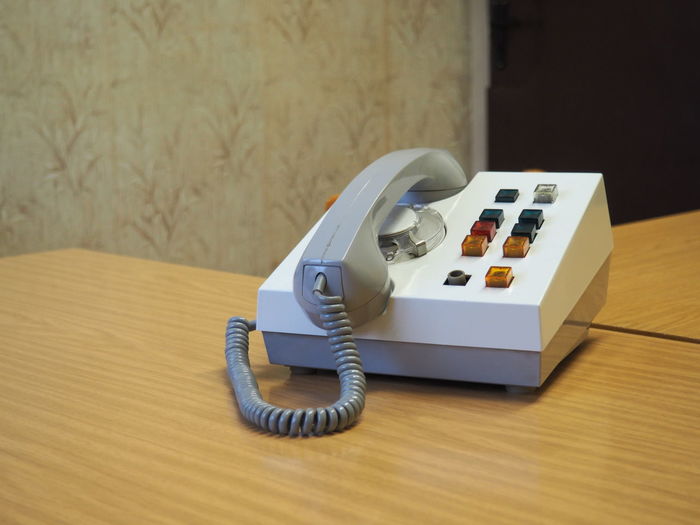 Close-up of old-fashioned telephone on table at prison