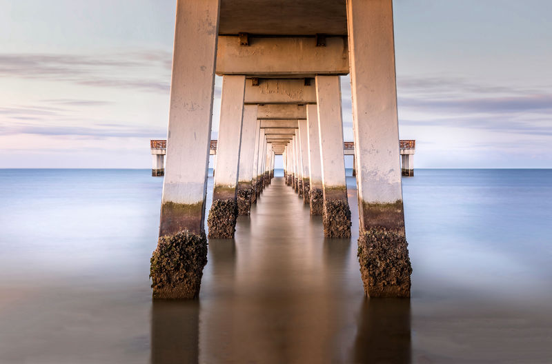 Pier over sea against sky