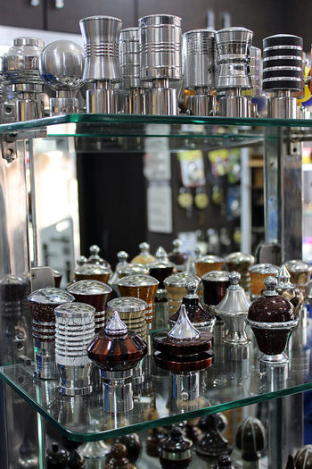 Various glass bottles on rack for sale in market