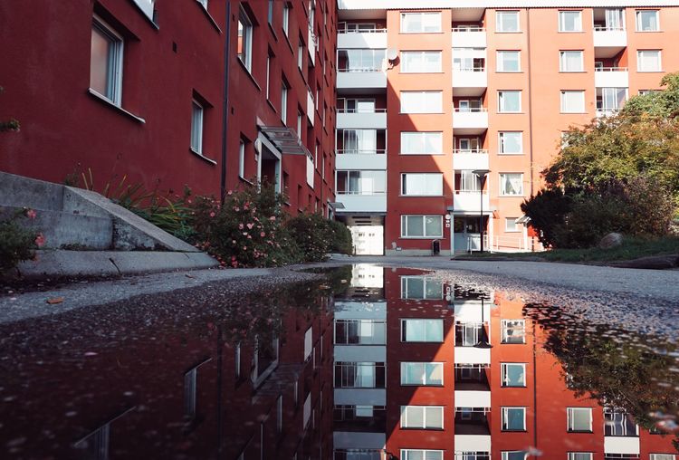 Residential buildings by puddle 