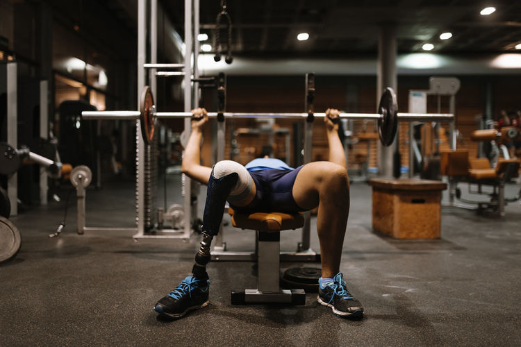 Disabled young man training in the sportsman Concept. Athlete Determination Effort Exercising Man Motivation Prosthetic Relaxing Young Concentration Fitness Gm Healthy Indoors Limitless Mobile One Person People Prosthesis Sport Sportman Strength Strong Weightlifting Workout