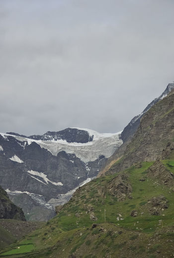View of glacier in between green mountains without trees in lahaul and spiti, himachal pradesh