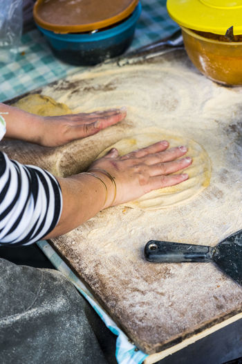 Cropped image of hand making flatbread