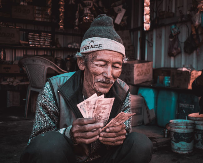 Smiling young man with paper currency