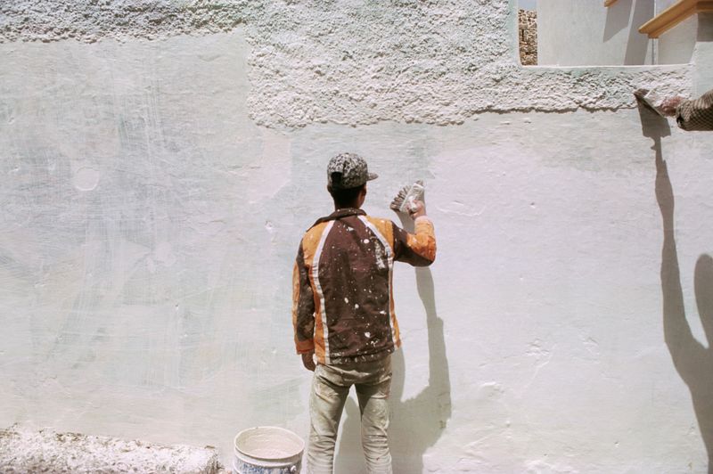 Rear view of man standing against wall