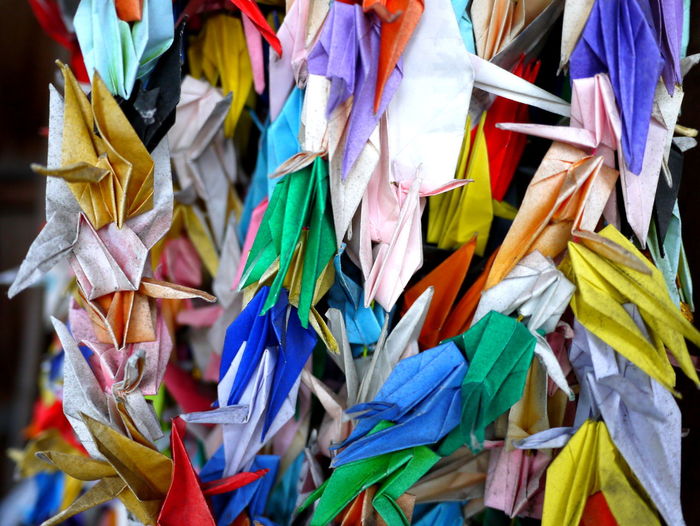 Colorful paper cranes hanging outdoors