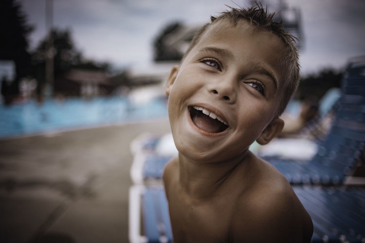 Portrait of smiling boy at poolside