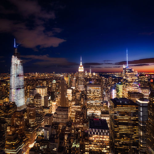 High angle view of city lit up at night