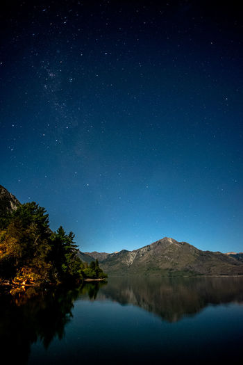 Scenic view of lake and mountain at night