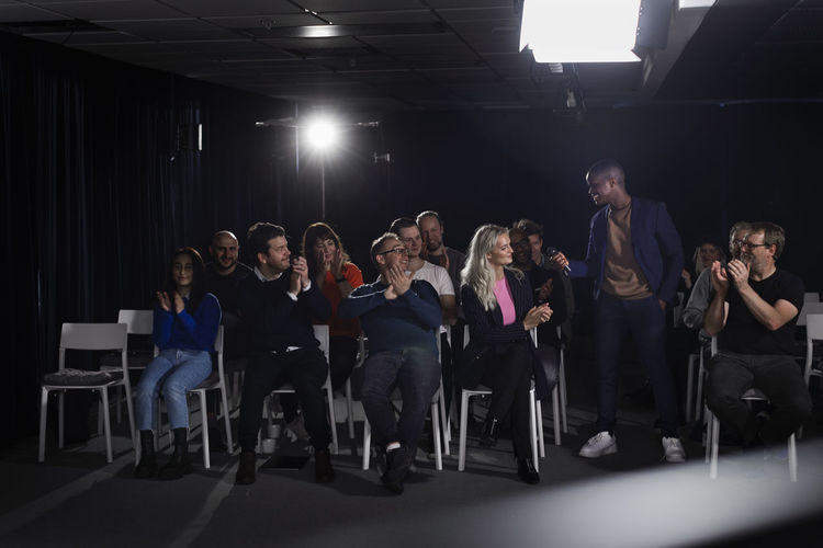 Tv show host interviewing audience member