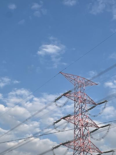 Low angle view of electricity pylon against sky