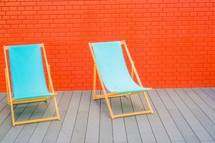 Empty chairs against wall