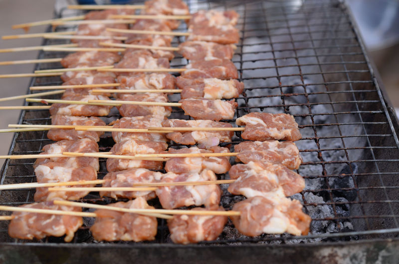 Fresh pork skewered on a charcoal grill, grilled pork, thai street food style