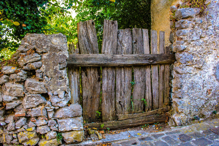 Old wooden door on stone wall