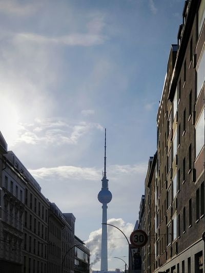 Low angle view of buildings and fernsehturm against sky