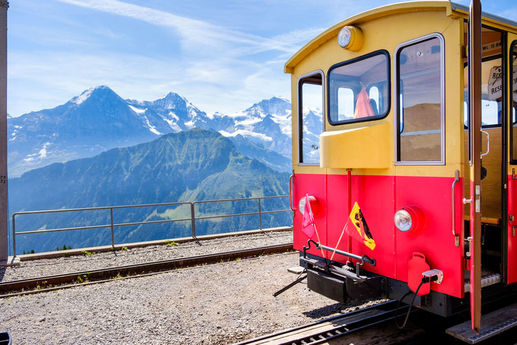 Train on railroad track against mountain range