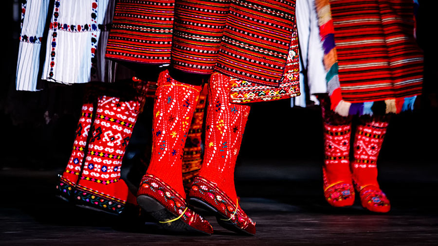 Low section of woman wearing traditional clothing while jumping on stage