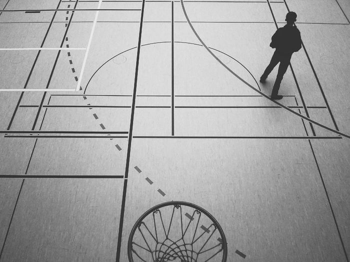 High angle view of boy standing in basketball court