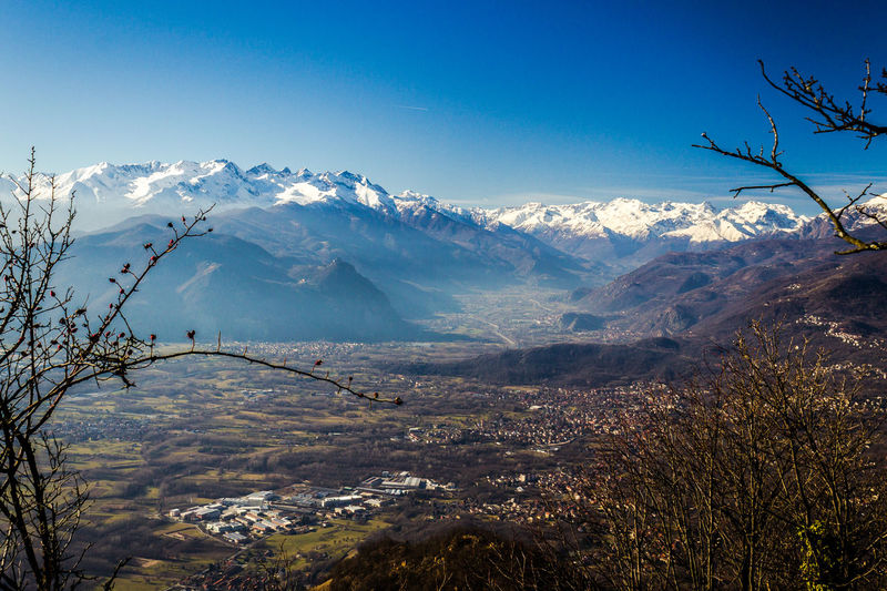 Scenic view of snowcapped mountains against sky and valley