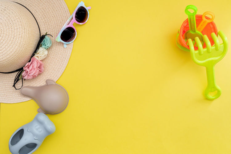 Directly above shot of personal accessories on yellow background