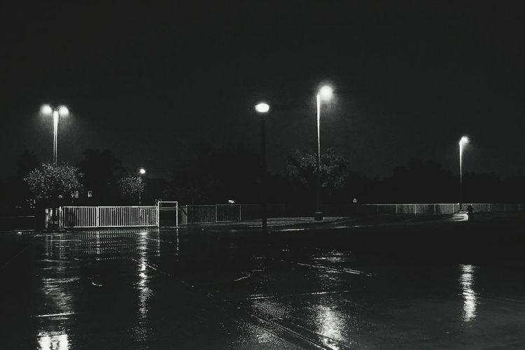 Reflection of illuminated lights in puddle
