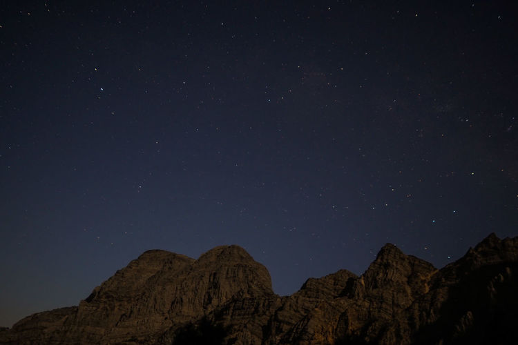 Low angle view of mountain against sky at night