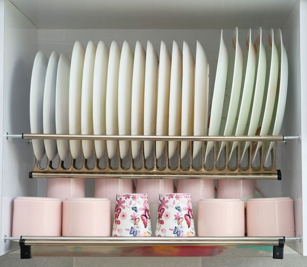 Row of kitchen utensils in rack at home