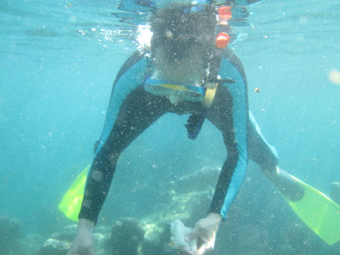 Full length of man scuba diving in sea