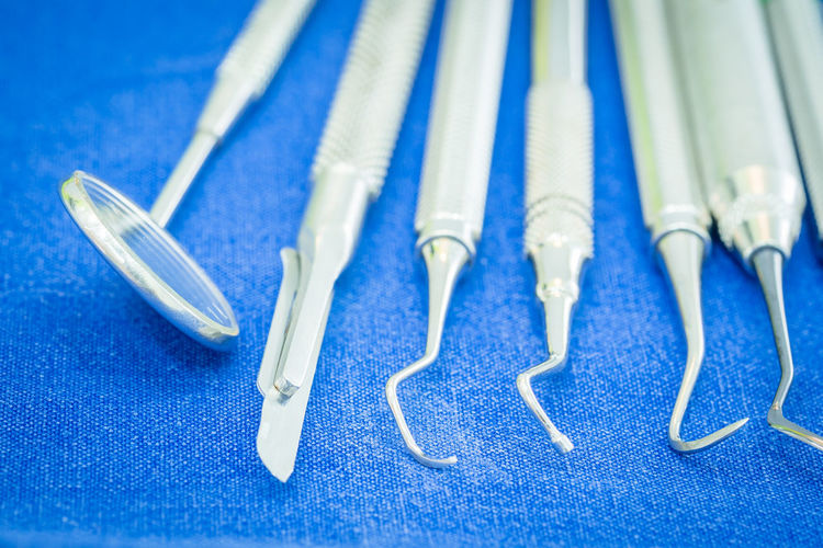 Close-up of dental instruments on blue textile
