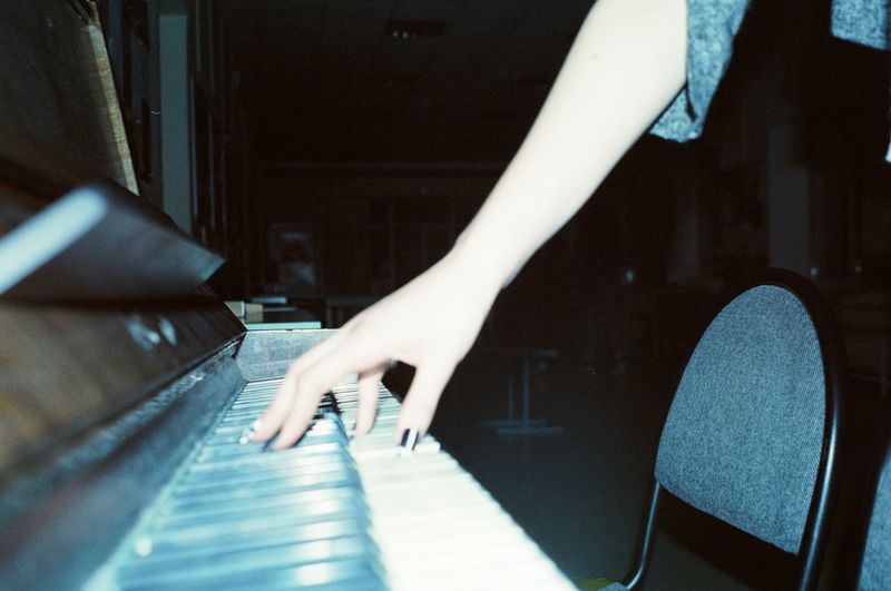 Woman's hand playing the piano, shot on film
