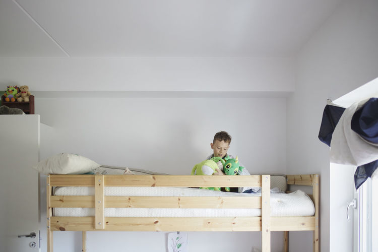 Boy playing in bunk bed
