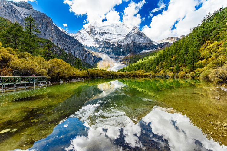 Scenic view of lake and mountains against sky