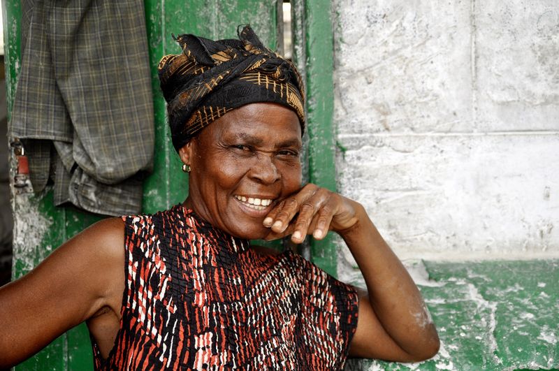 Portrait of smiling woman against wall