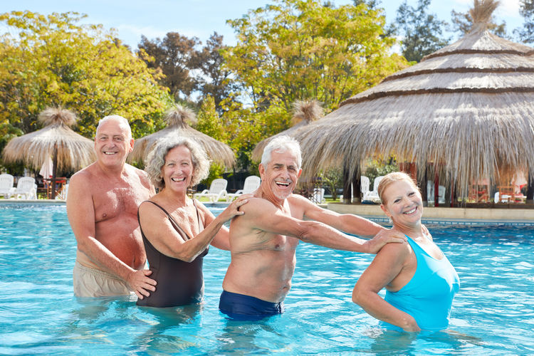 Portrait of senior people standing in swimming pool