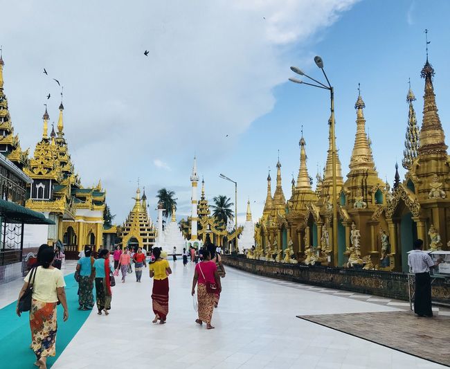 Group of people walking in temple against building