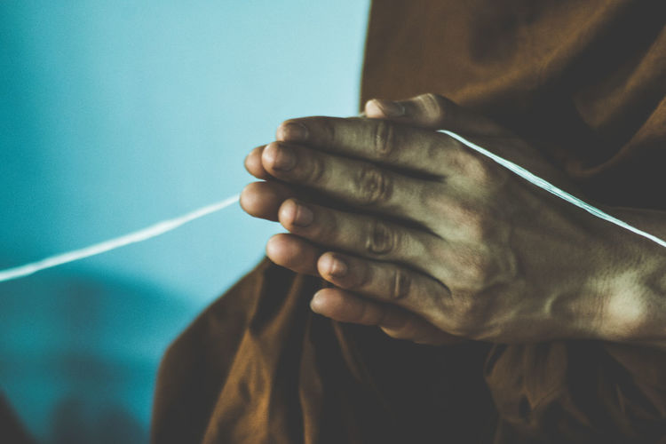Close-up of hands clasped 