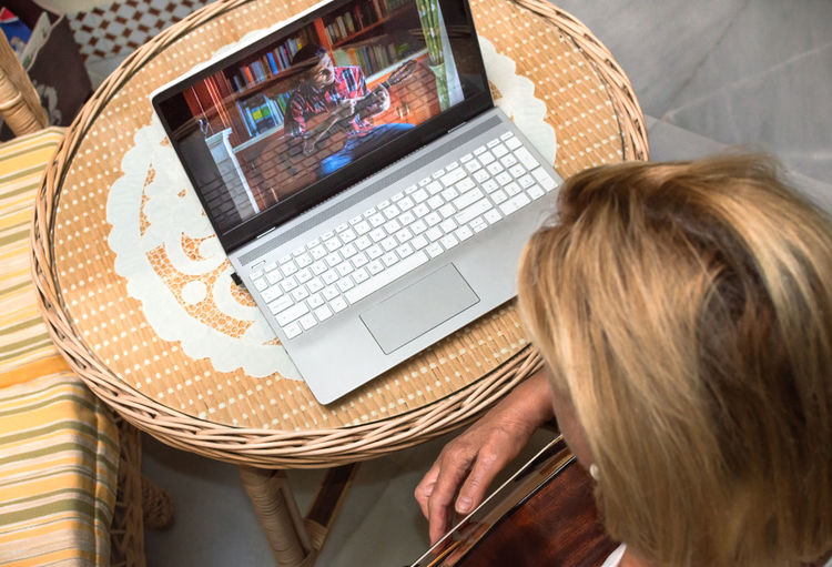 High angle view of woman using laptop on table