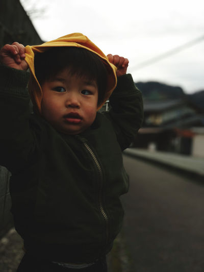 Portrait of boy wearing hat standing outdoors