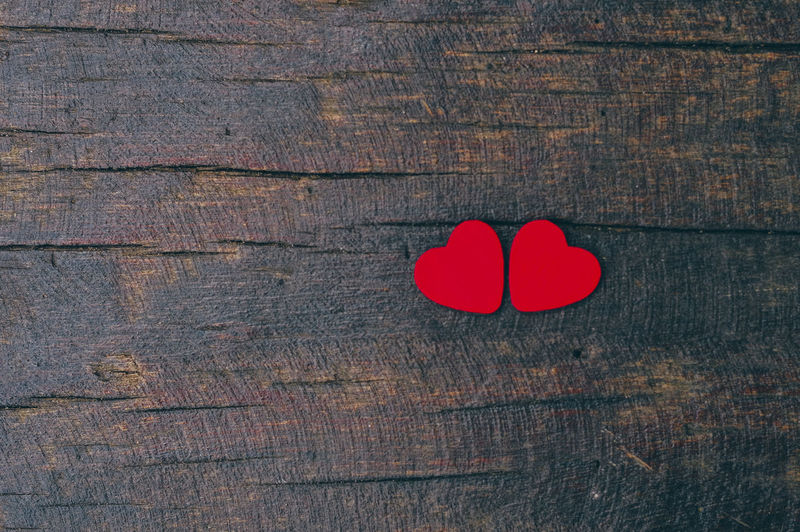 Close-up of red heart shapes on wooden table