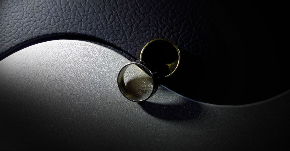 Close-up of wedding rings on yin yang symbol