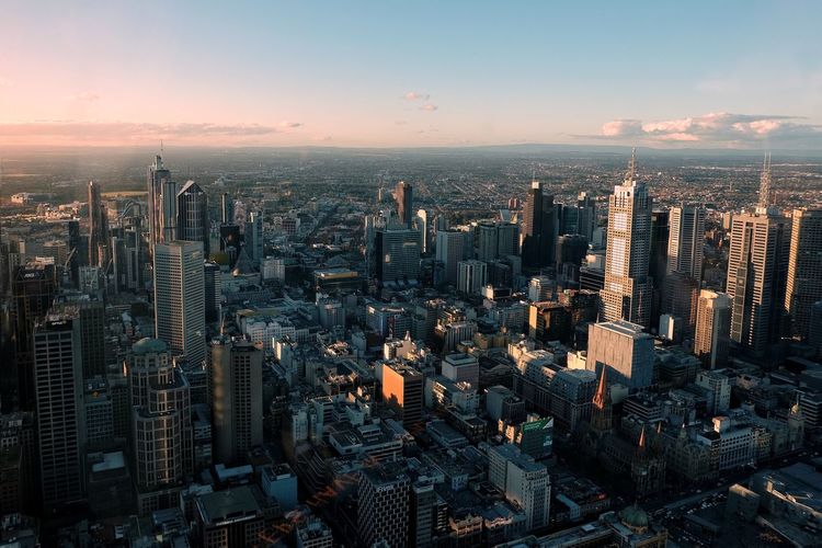 High angle view of modern buildings in city against sky during sunset, melbourne australia 
