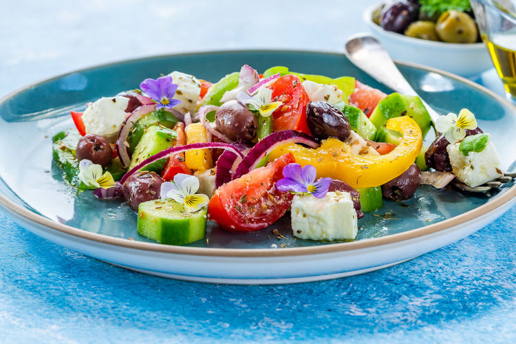 Traditional greek salad with fresh vegetables and feta cheese - healthy food idea