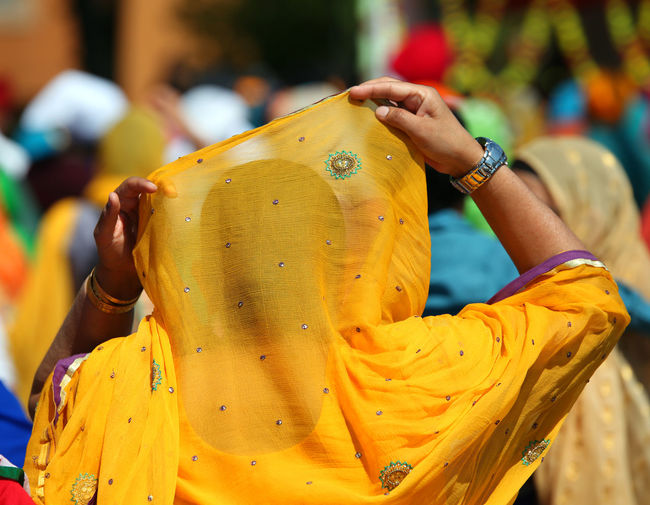 Woman with yellow veil during a religious parade