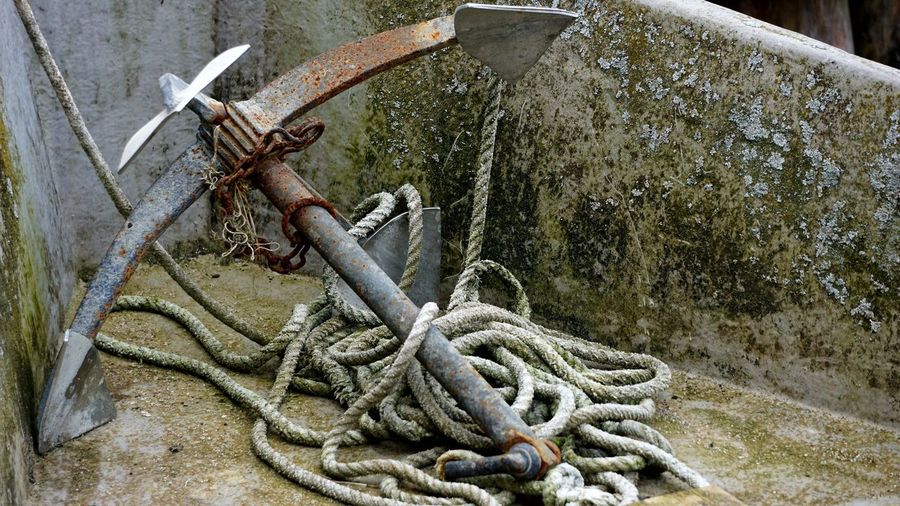 High angle view of rope tied up on rusty metal