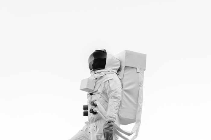 Person wearing astronaut costume while standing against white background